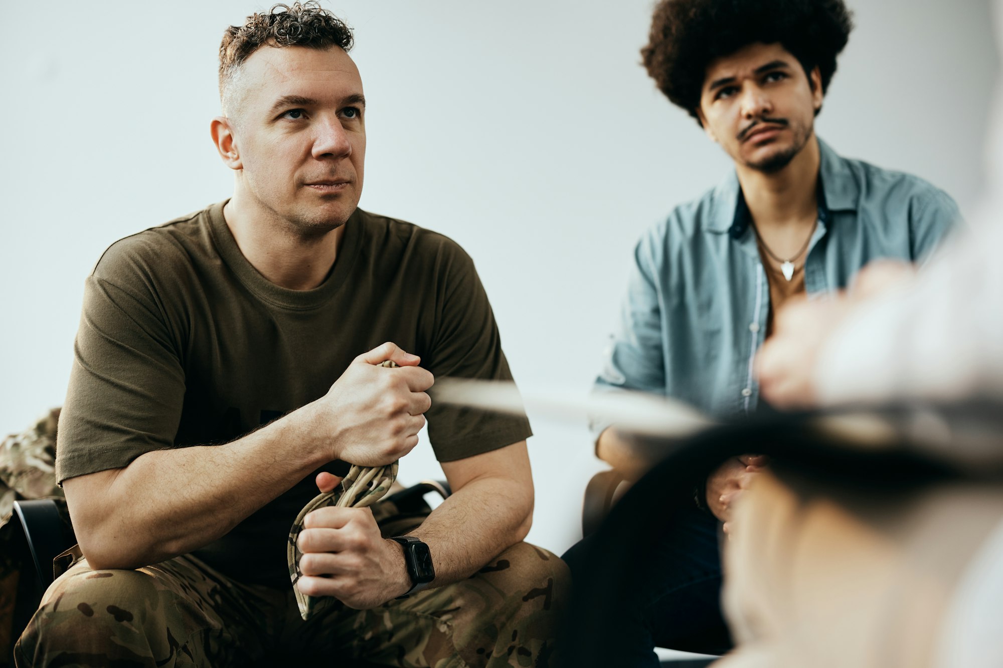 Mid adult veteran attending group therapy session at mental health center.