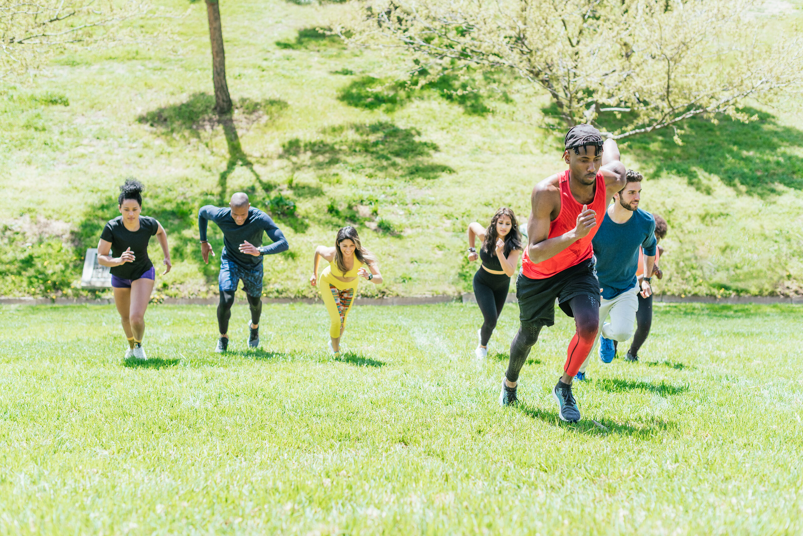 a group of runners running up a hill as part of exercise for addiction recovery